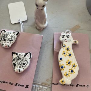 A variety of cat earrings, and pins for the cat lover.